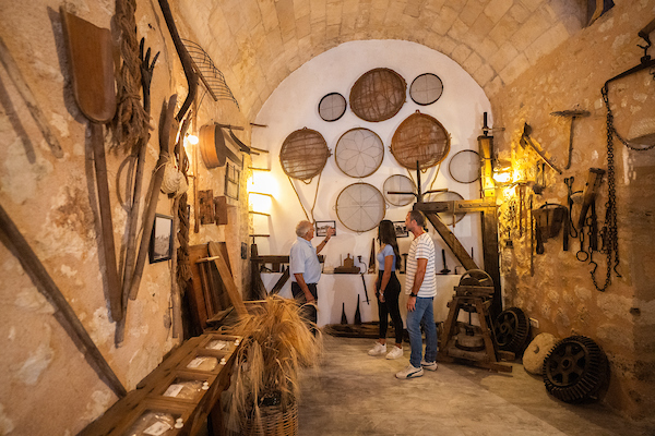 Hombre explicándole a una pareja las tradiciones de los molinos del Pla